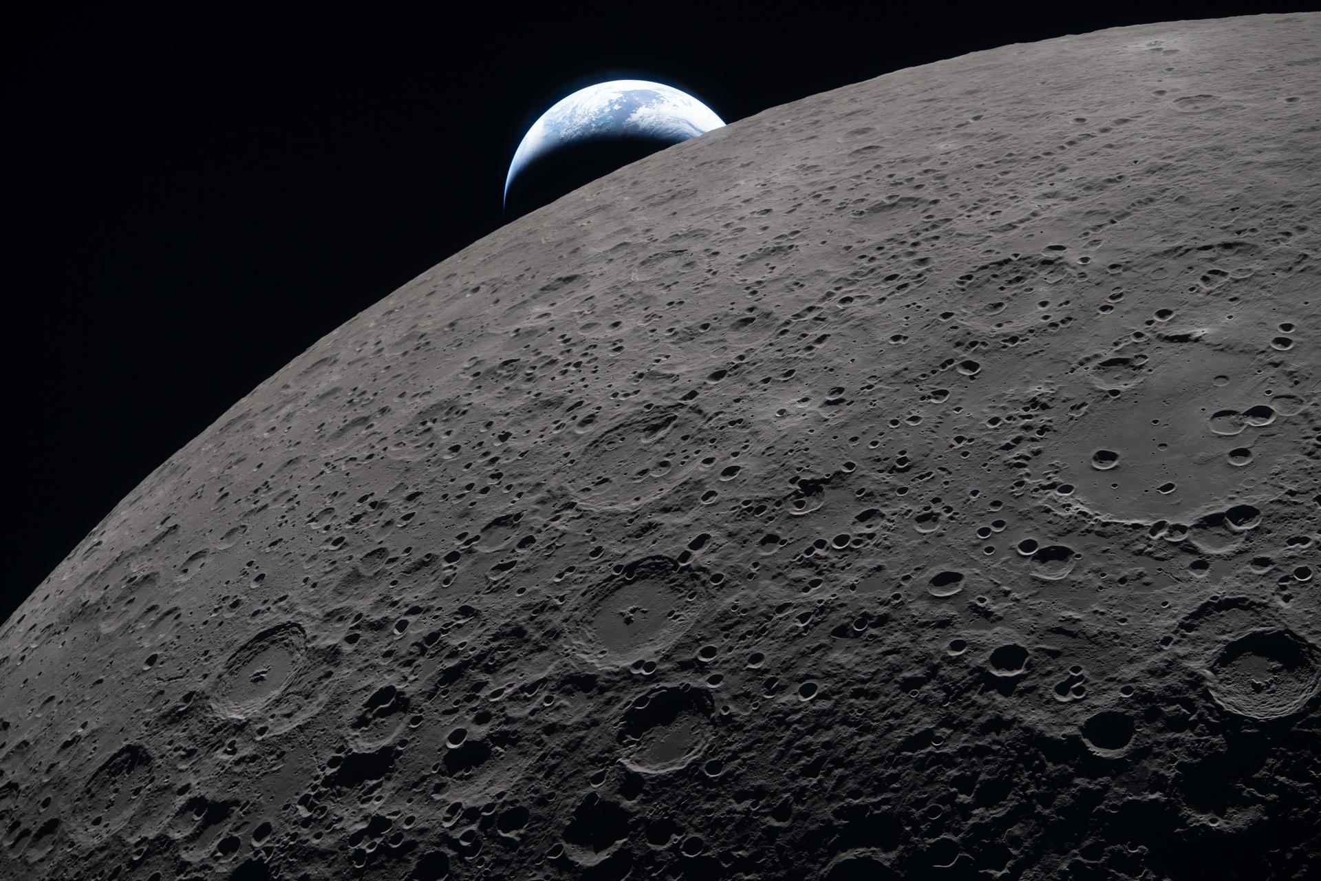 The Moon's curved surface with Earth visible in the background against the darkness of space